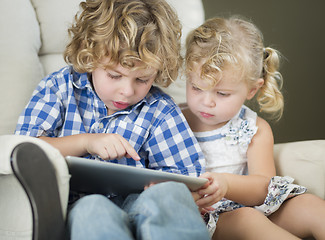 Image showing Young Brother and Sister Using Their Computer Tablet Together