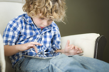 Image showing Young Blond Boy Using His Computer Tablet