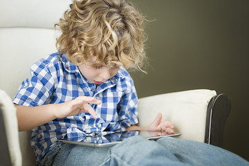 Image showing Young Blond Boy Using His Computer Tablet