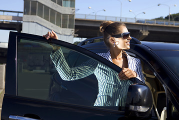 Image showing happy business woman near city bridge