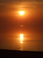 Image showing Orange sunset above a quiet serene gulf