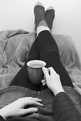 Image showing Woman dressed warmly, relaxing with a hot drink