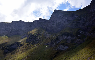 Image showing Autumn sunlit mountains in a cloudy day