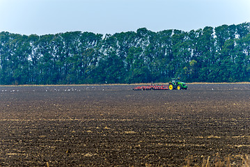 Image showing Tractor plowing the land