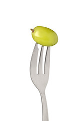 Image showing Green grape held by a fork