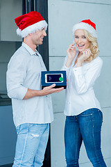 Image showing Husband giving his wife a Christmas gift