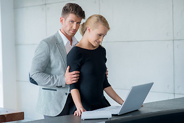 Image showing Sweet Young Lovers Using Laptop on Table