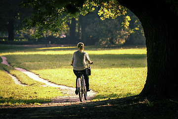 Image showing Young woman on bike