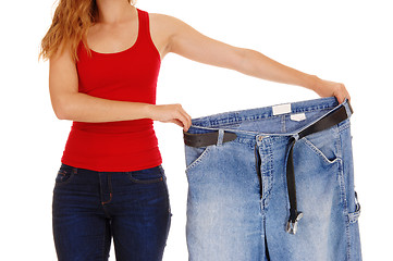 Image showing Woman holding big pants.