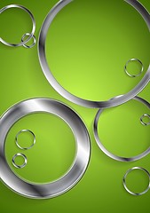 Image showing Bright green backdrop with metallic circles