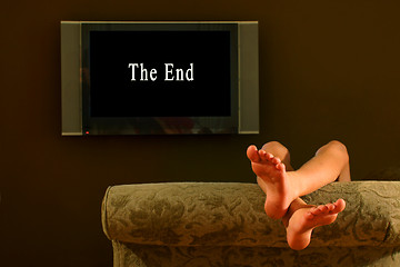 Image showing child reclining feet up watching the end of a movie