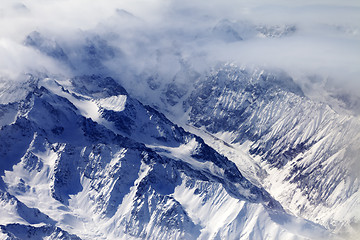 Image showing Top view on snow mountains and glacier in mist