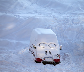 Image showing Snow-covered car with smiley in windshield