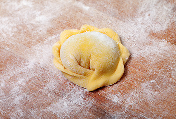 Image showing Raw ravioli on wooden cutting board