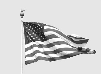 Image showing The American flag flies on a sunny day against a clear sky