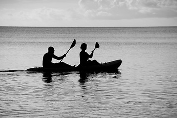 Image showing Kayakers silhouetted on the ocean