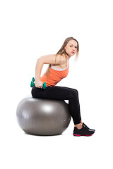 Image showing Young blonde training with dumbbells