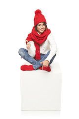 Image showing Winter woman sitting on blank billboard placard sign