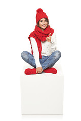 Image showing Winter woman sitting on blank billboard placard sign