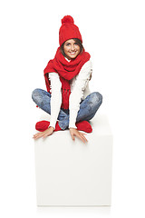 Image showing Winter woman sitting on blank billboard placard sign