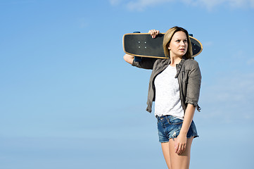 Image showing Skateboarding girl looking back