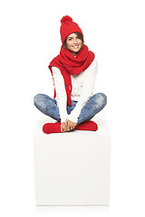 Image showing Winter woman sitting on blank billboard placard sign
