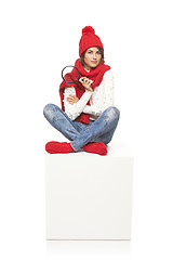 Image showing Winter woman sitting on blank billboard placard sign