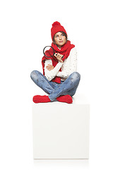 Image showing Winter woman sitting on blank billboard placard sign