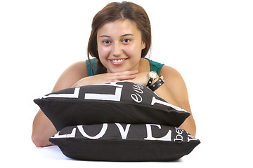 Image showing Teenage girl lying over pillows 