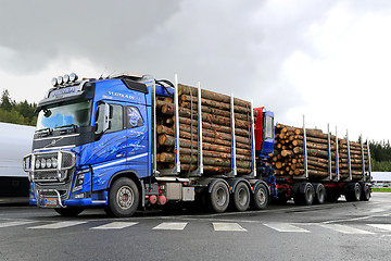 Image showing Blue Volvo FH16 700 Timber Truck with Log Trailer