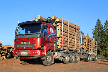 Image showing Red Sisu 18E630 Timber Truck Ready to Unload Logs