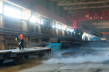 Image showing Worker cleans railway platform