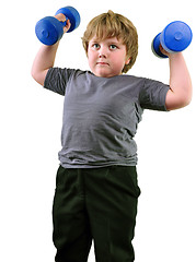 Image showing isolated portrait of elementary age boy with dumbbells exercising 