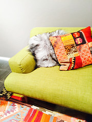 Image showing Bright green sofa with colorful cushions