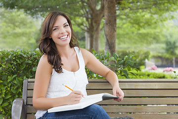 Image showing Young Adult Female Student on Bench Outdoors