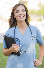 Image showing Young Adult Woman Doctor or Nurse Holding Touch Pad Outside