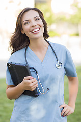 Image showing Young Adult Woman Doctor or Nurse Holding Touch Pad Outside