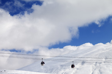 Image showing Gondola lifts and off-piste slope at sun day