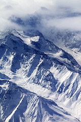 Image showing Top view on snow mountains and glacier in fog