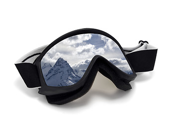 Image showing Ski goggles with reflection of snow mountains