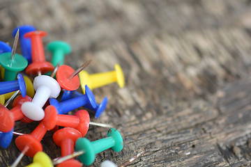 Image showing old push pins set on old wooden background