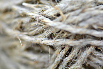 Image showing Close-up of an old frayed boat rope as a nautical background. Sepia