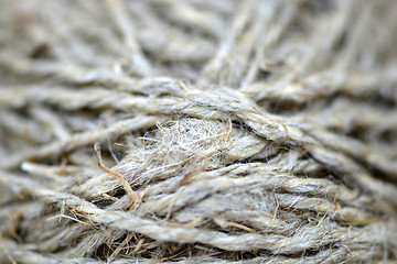 Image showing Close-up of an old frayed boat rope as a nautical background. Sepia