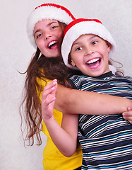 Image showing happy children with Santa Claus red hats