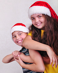 Image showing happy children with Santa Claus red hats