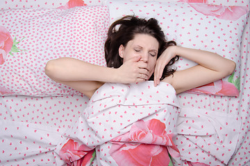 Image showing The girl woke up yawning in bed