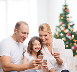 Image showing happy family with smartphones