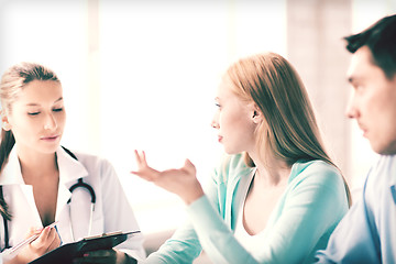 Image showing doctor with patients in cabinet