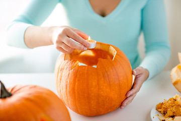 Image showing close up of woman with pumpkins at home