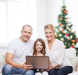 Image showing happy family with laptop computer